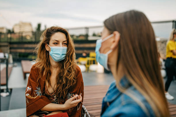 istock Two young woman greeting each other 1271314357
