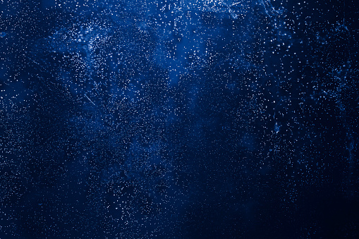 Old dark blue wall with dots, abstract background