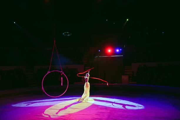 istock Aerial acrobat in the ring. A young girl performs the acrobatic elements in the air ring. 1271316487