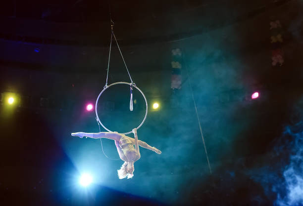 istock Aerial acrobat in the ring. A young girl performs the acrobatic elements in the air ring. 1271317011