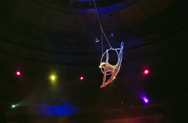 istock Aerial acrobat in the ring. A young girl performs the acrobatic elements in the air ring. 1271317019