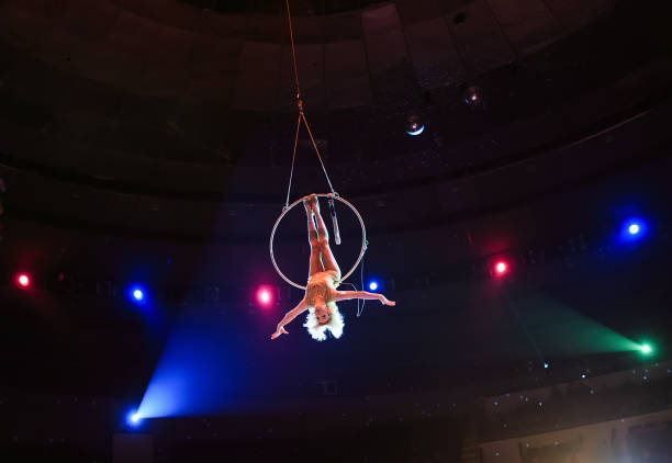 istock Aerial acrobat in the ring. A young girl performs the acrobatic elements in the air ring. 1271317025