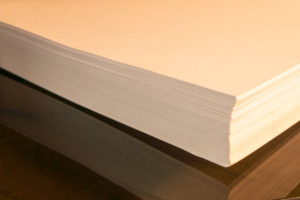 istock stack of white paper rests on brown glass 1271317128