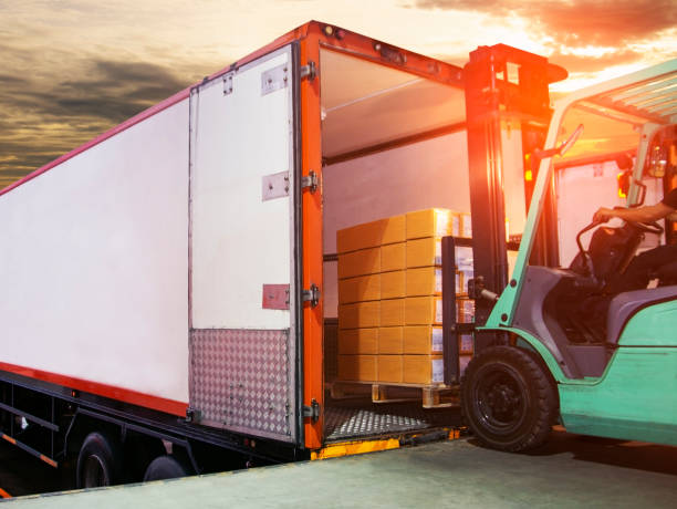 istock Cargo freight, Shipment, Delivery service. Logistics and transportation. Forklift loading goods boxes on pallet into container truck. 1271317941