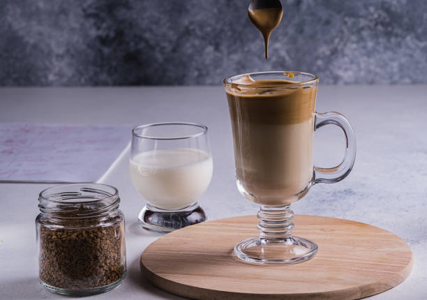 istock Dalgona espresso latte and ingredients for its preparation on gray background. Selective focus. 1271322685