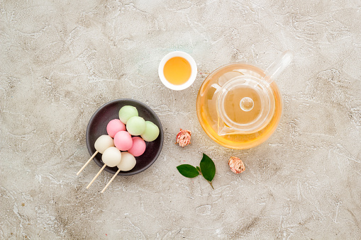 Japanese food background with sweets and tea. Three colored dumplings Dango.
