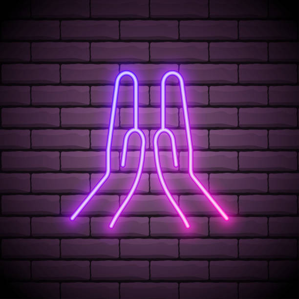istock Praying glowing neon ui ux icon. Glowing sign logo vector isolated on dark brick wall 1271327521