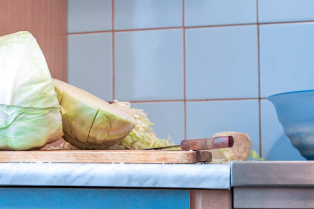fresh white cabbage lies on a wooden board, sliced for pickling for the winter