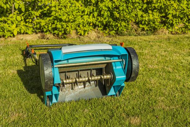 view of electric lawn aerator on green grass isolated. garden machines concept. - aeration imagens e fotografias de stock