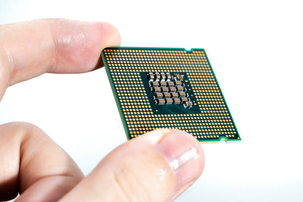 istock Close-up view of a man's hand holding a computer processor chip isolated 1271328113
