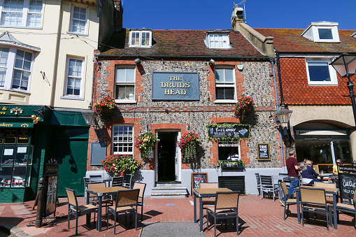 The Druids Head gastro pub on a summer day in Brighton, England. People can be seen dining outside.