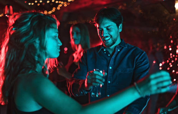 istock Young couple dancing in night club 1271329143