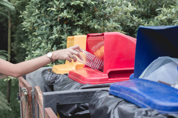 istock Woman drop plastic bottle into recycle bin. 1271330391