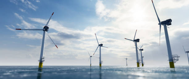 istock Offshore wind power and energy farm with many wind turbines on the ocean 1271332425