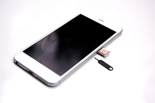 Side view Sim card tools, Small nano sim card card tray with smartphones Selective focus