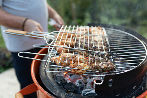 Man grilling meat on a barbecue grill