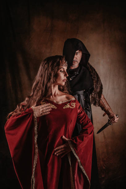istock Medieval black knight threaten lady with a dagger 1271333890