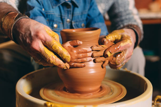 istock Pottery workshop. Grandpa teaches granddaughter pottery. Clay modeling 1271333967
