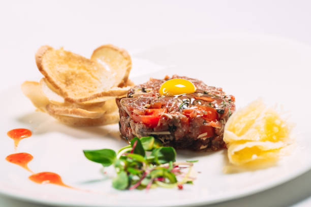 istock Tartar dish in the restaurant on a white plate on white background 1271334171