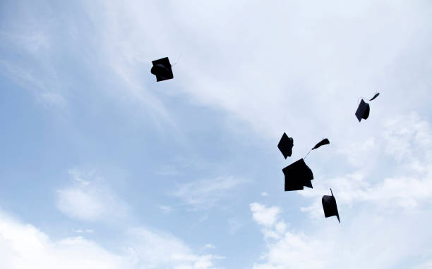 istock Graduation hat Thrown in the Air with blue sky  background. 1271335272