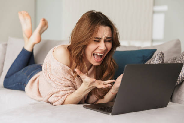 istock Portrait of an angry young woman using laptop computer 1271335565