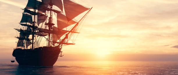 istock Pirate ship sailing on the ocean at sunset 1271335643