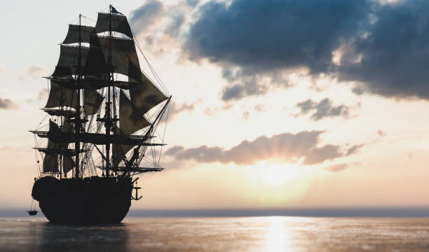 istock Pirate ship sailing on the ocean at sunset 1271335654