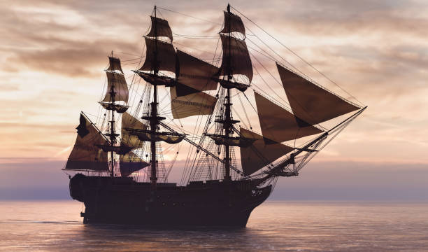istock Pirate ship sailing on the ocean at sunset 1271335658