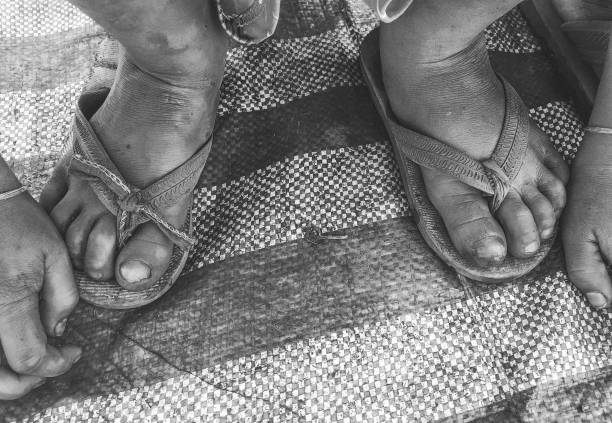 Asian male feet wearing sandals outdoors.  stock photos