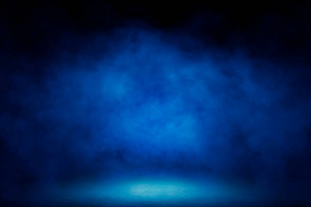istock Studio dark room with blue lighting effect and fog in black background. 1271337010