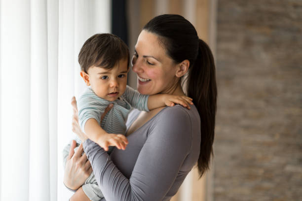 istock Mother and her baby boy playing 1271337375