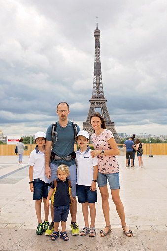 Happy family with children, visiting Paris during the summer