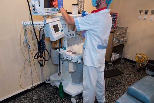 Male cleaning staff perform cleaning and disinfection tasks in the hospital.