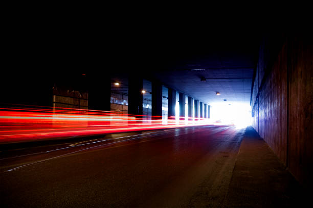 Old dark tunnel with colorful trails of light.