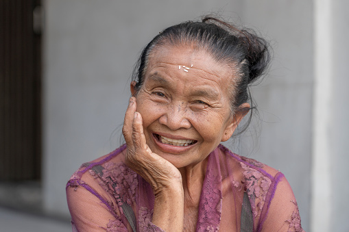 Ubud, island Bali, Indonesia - march 20, 2019 : Portrait of a indonesian old woman on a street in the city of Ubud in Bali, Indonesia