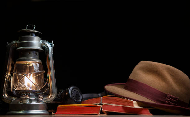 istock image of book lamp hat dark background 1271339625