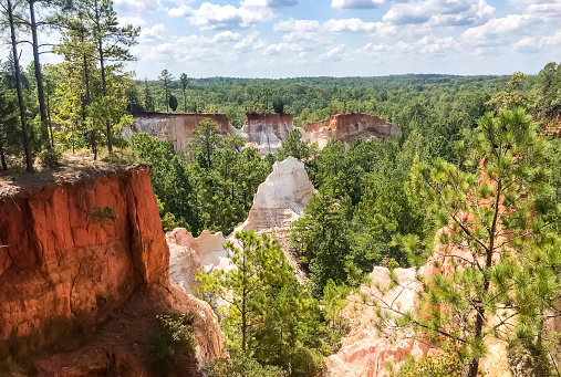 A miniature version of the Grand Canyon is on display in Georgia, USA. Providence Canyon is full of rock formations that make for a pleasant view while hiking. Many come and visit this site. On this bright day in Summer it was a pleasant site to behold.