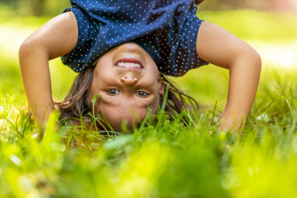 istock Child doing hand stand in park 1271340843