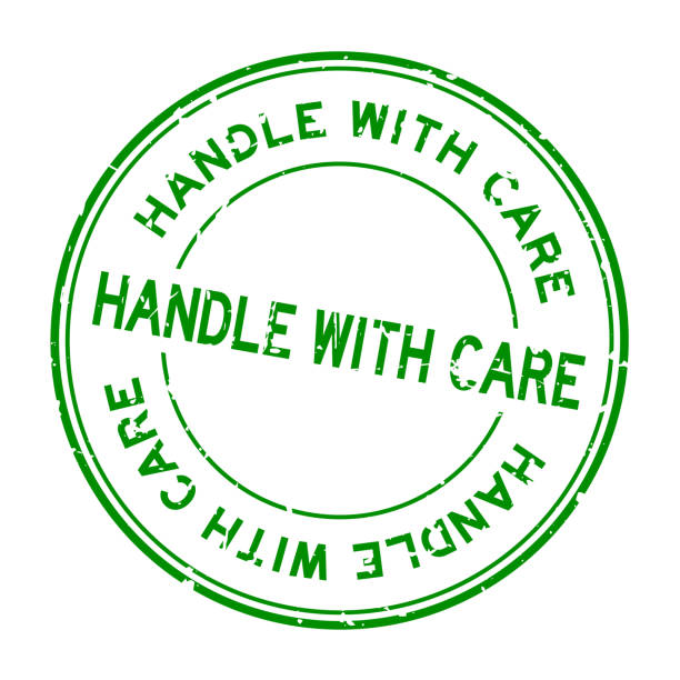 istock Grunge green handle with care word round rubber seal stamp on white background 1271344695