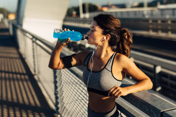 istock Sportswoman resting and hydrating on the bridge 1271346089
