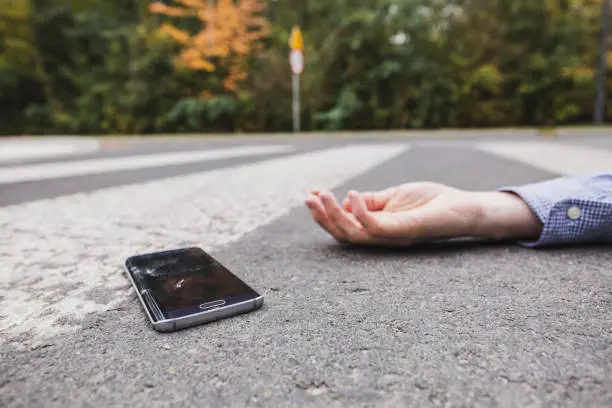 Man with a cell phone on the street after the accident