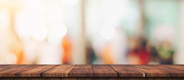 istock Empty wood table and blurred light table in shopping mall with bokeh background. product display template. 1271348019