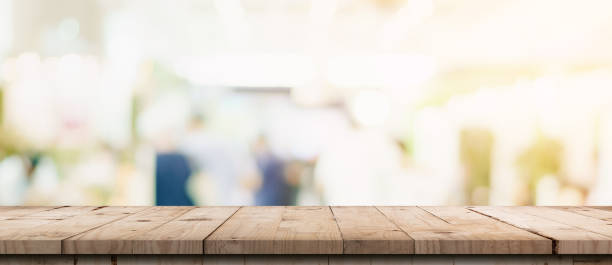 istock Empty wood table and blurred light table in shopping mall with bokeh background. product display template. 1271348048