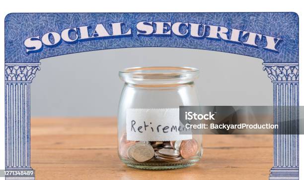 Loose Change Inside Glass Jar To Represent Retirement Savings For Social Security Stock Photo - Download Image Now