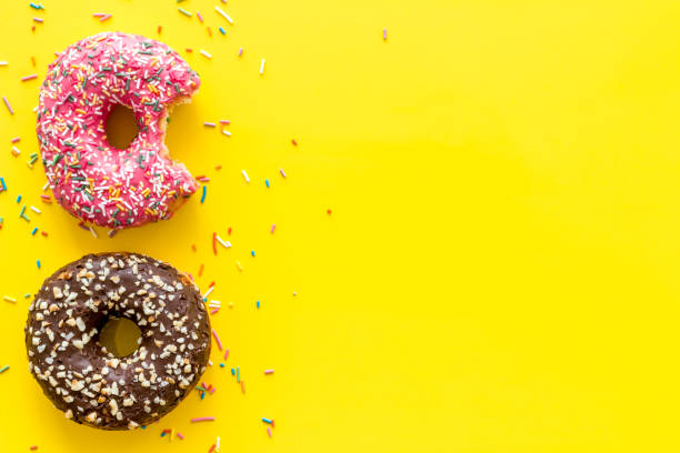 istock Top view of colorful glazed donut swith sprinkles, copy space 1271350868