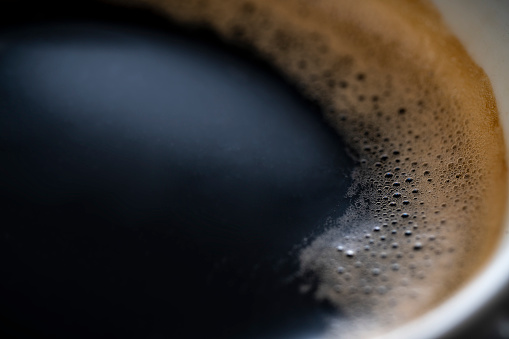 Coffee cup macro with bubbles and foam detail close-up