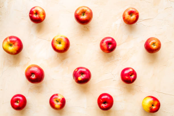 istock Fruit pattern of red apples on table desk top view 1271353179