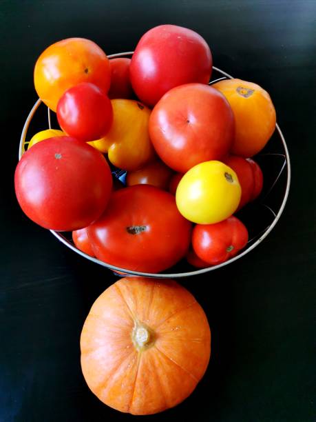 Heirloom raw organic vegetables on a white textured wooden background