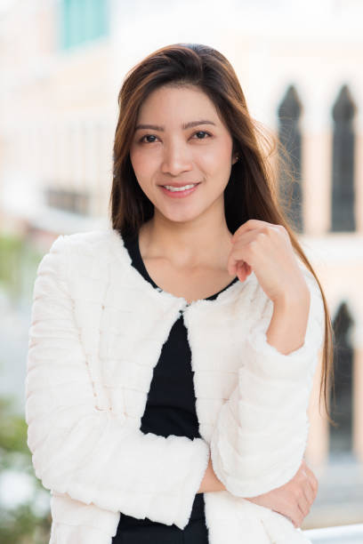 A beautiful Asian woman with a smiling face on a blurred background. stock photo