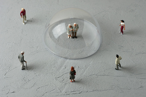 Old Couple figurine in glass dome. Quarantine concept.